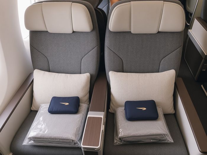 British Airways World Traveller Plus seats with pillow, blanket and amenity kit